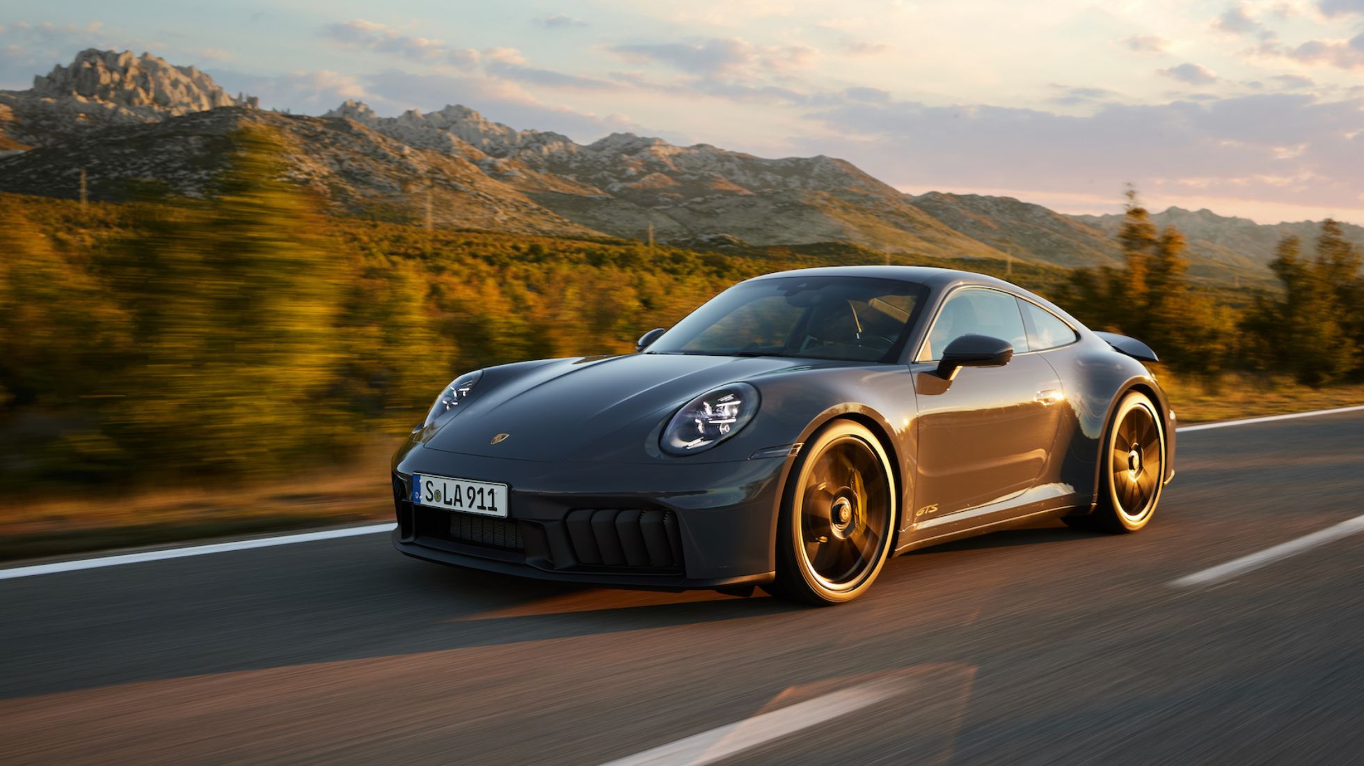 Refreshed Porsche 911 with hybrid power breaks cover