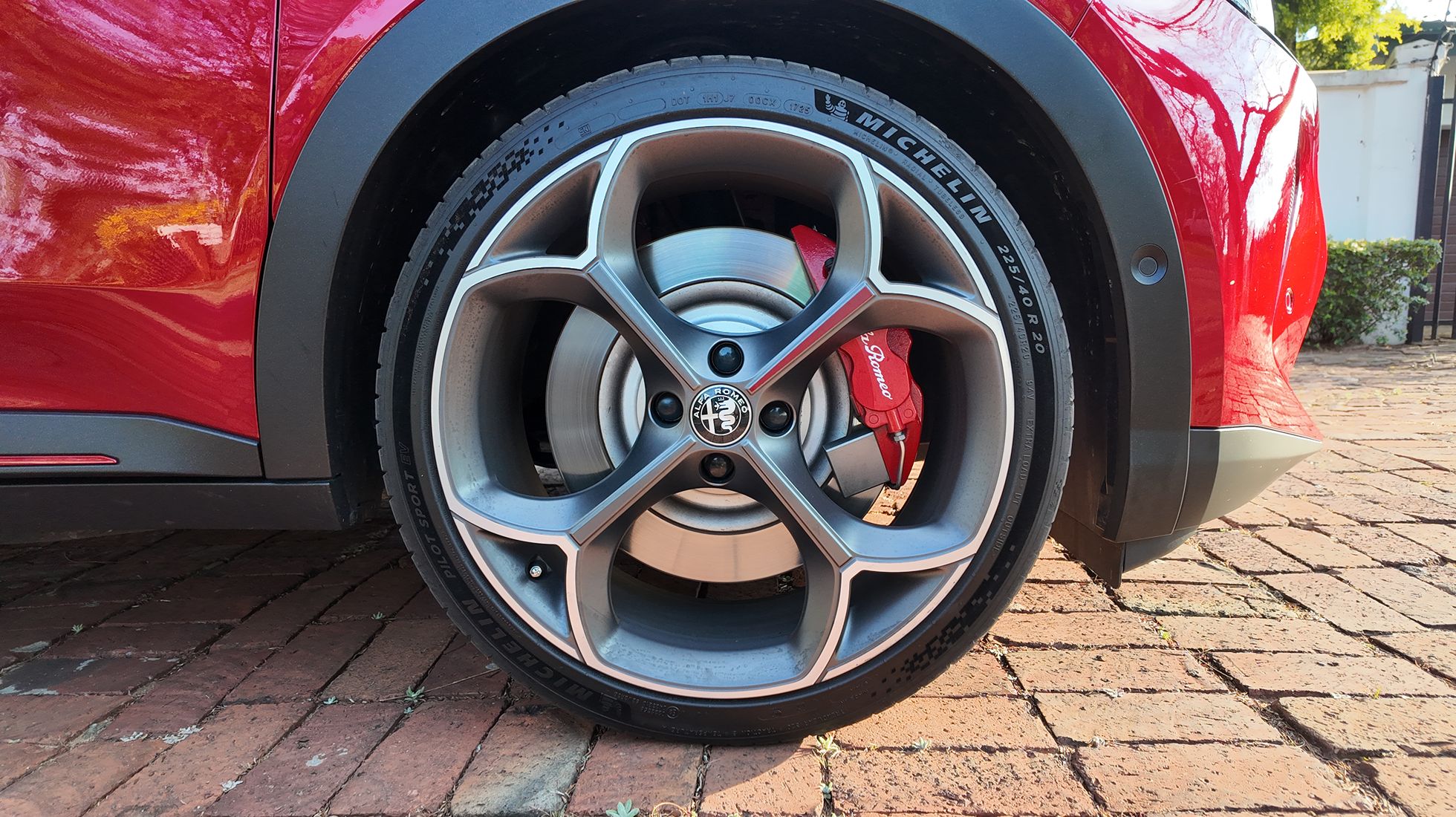 Alfa Romeo Junior Elettrica Veloce 20-inch alloy wheel with Michelin tyre and red Alfa Romeo brake calliper.