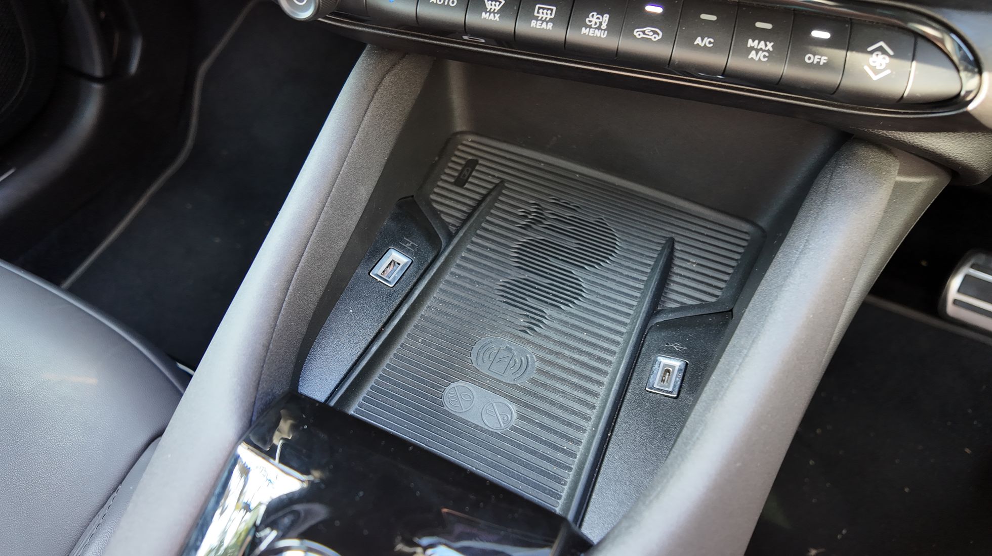 Alfa Romeo Junior Elettrica Veloce centre console showing the wireless charging pad, USB ports and climate controls.