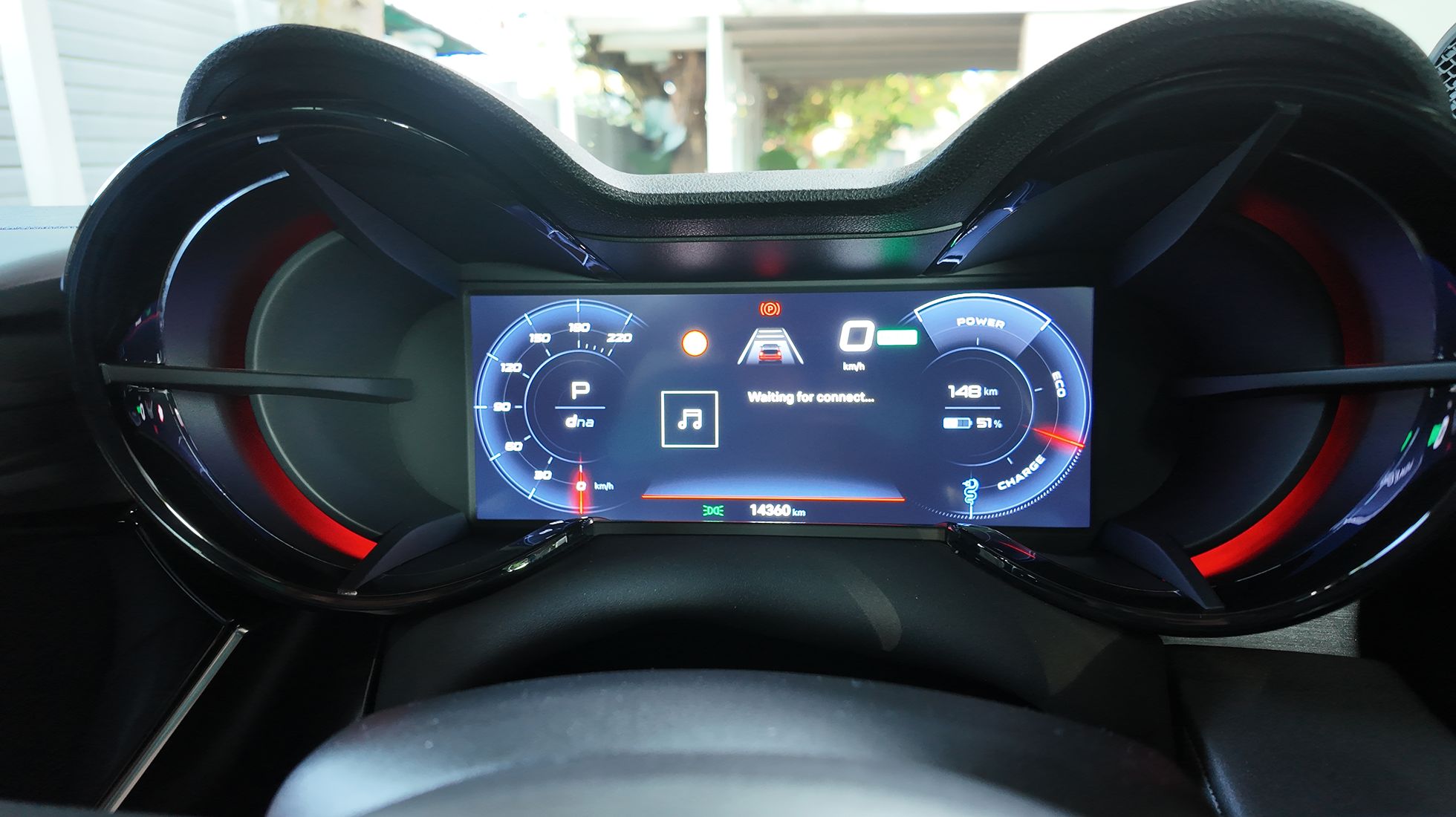 Digital instrument cluster of the Alfa Romeo Junior Elettrica Veloce displaying driving information, battery charge and estimated range.