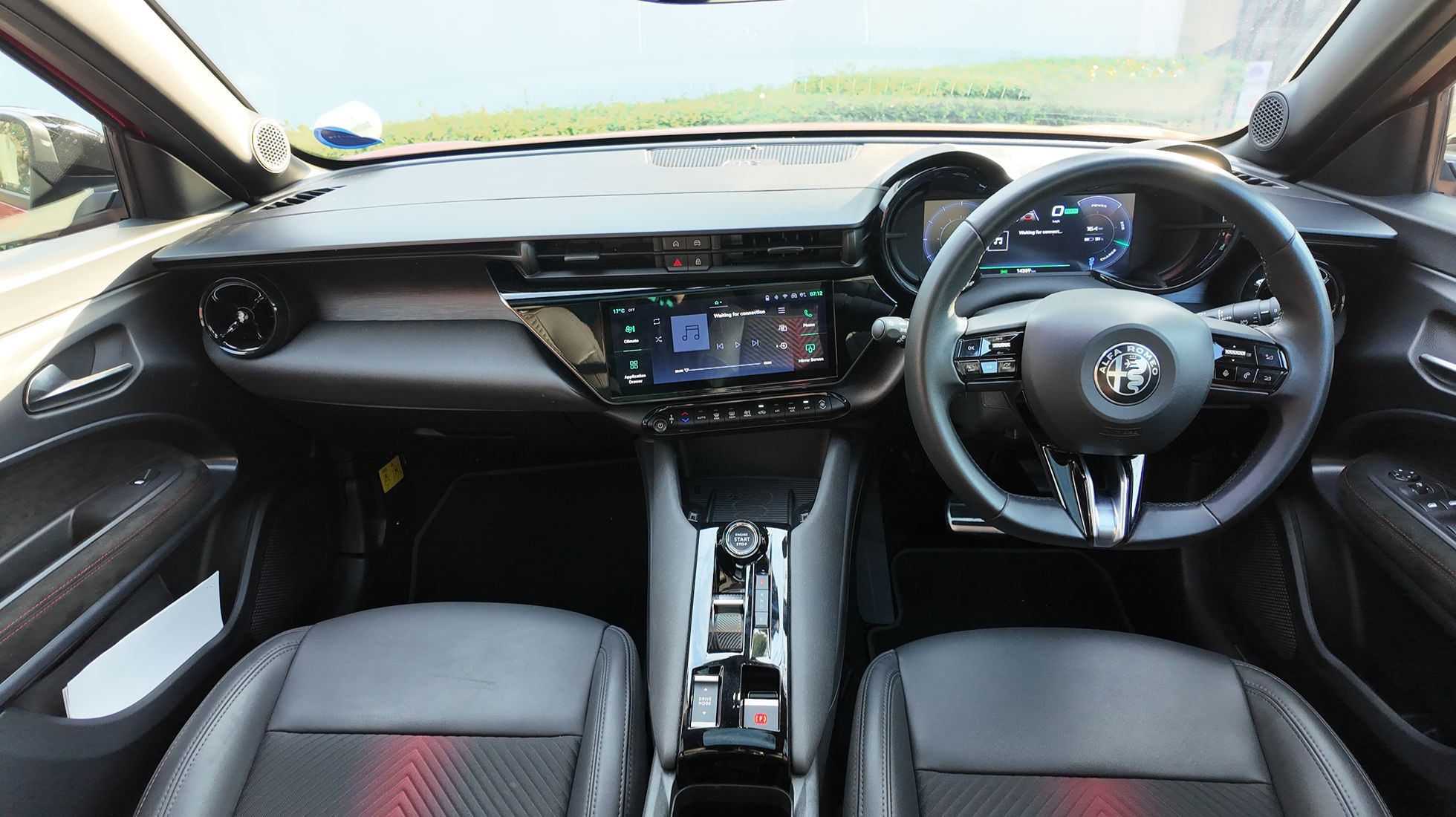 Alfa Romeo Junior Elettrica Veloce interior featuring digital displays, sporty steering wheel and driver-focused dashboard